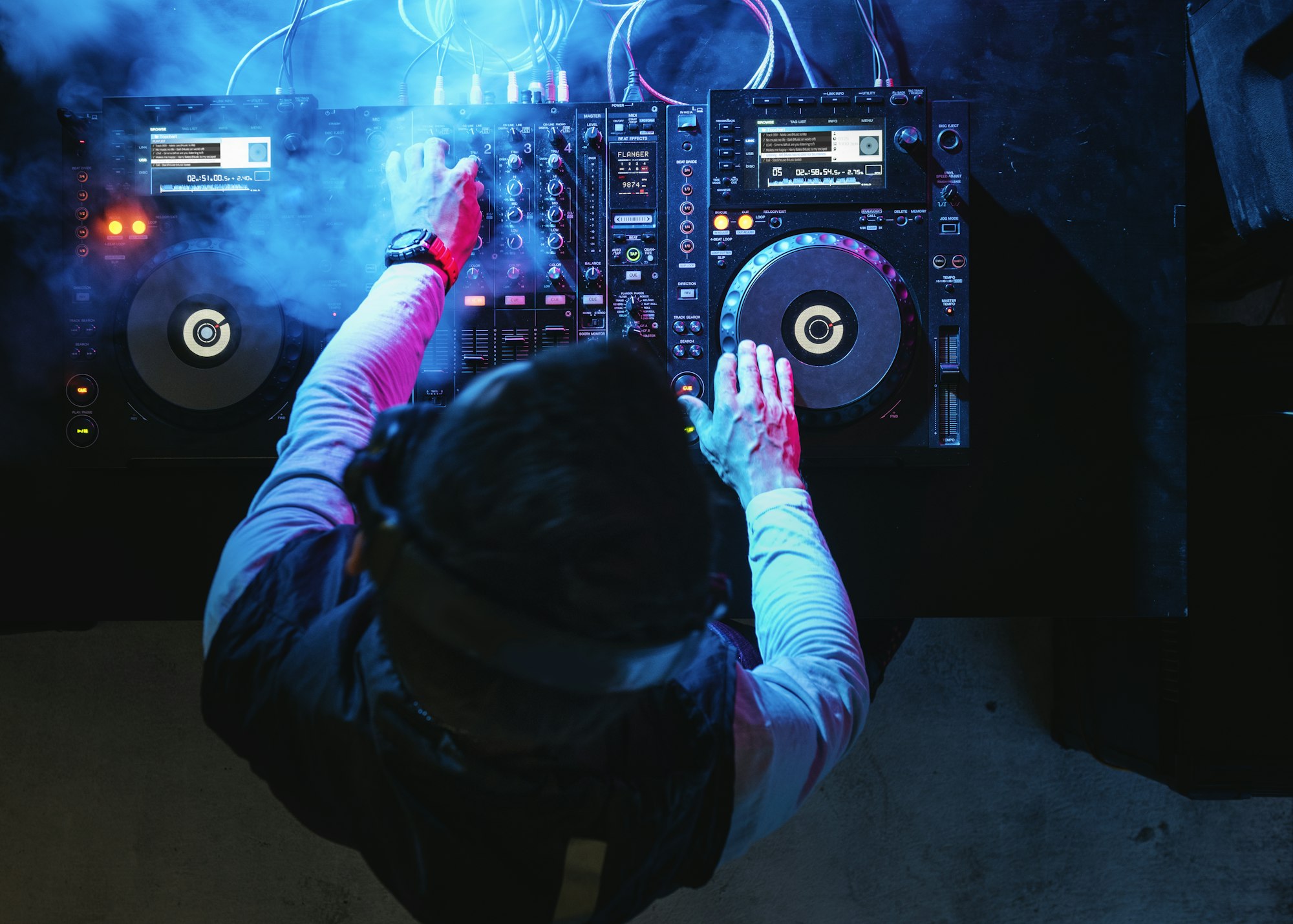 dj-playing-music-at-sound-mixer-in-night-club.jpg